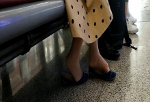 Lady dangling shoeplay when waiting for a train 35