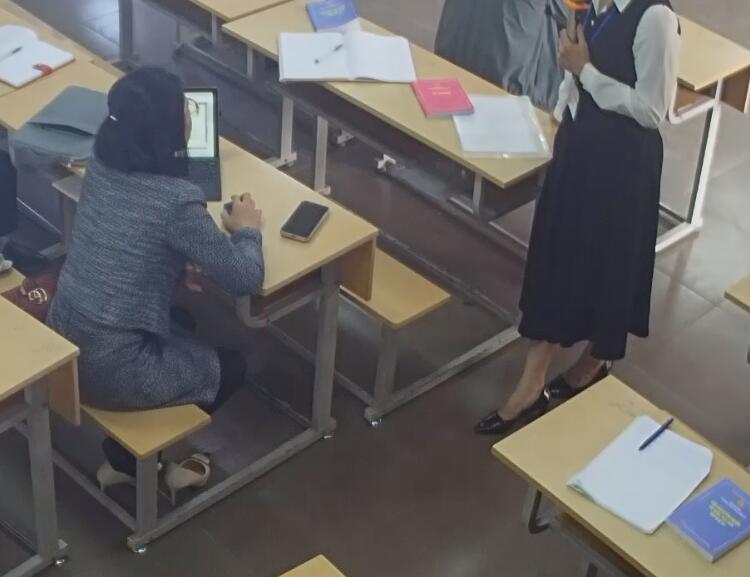 The lady in black nylon and white heels dipping shoeplay under the table