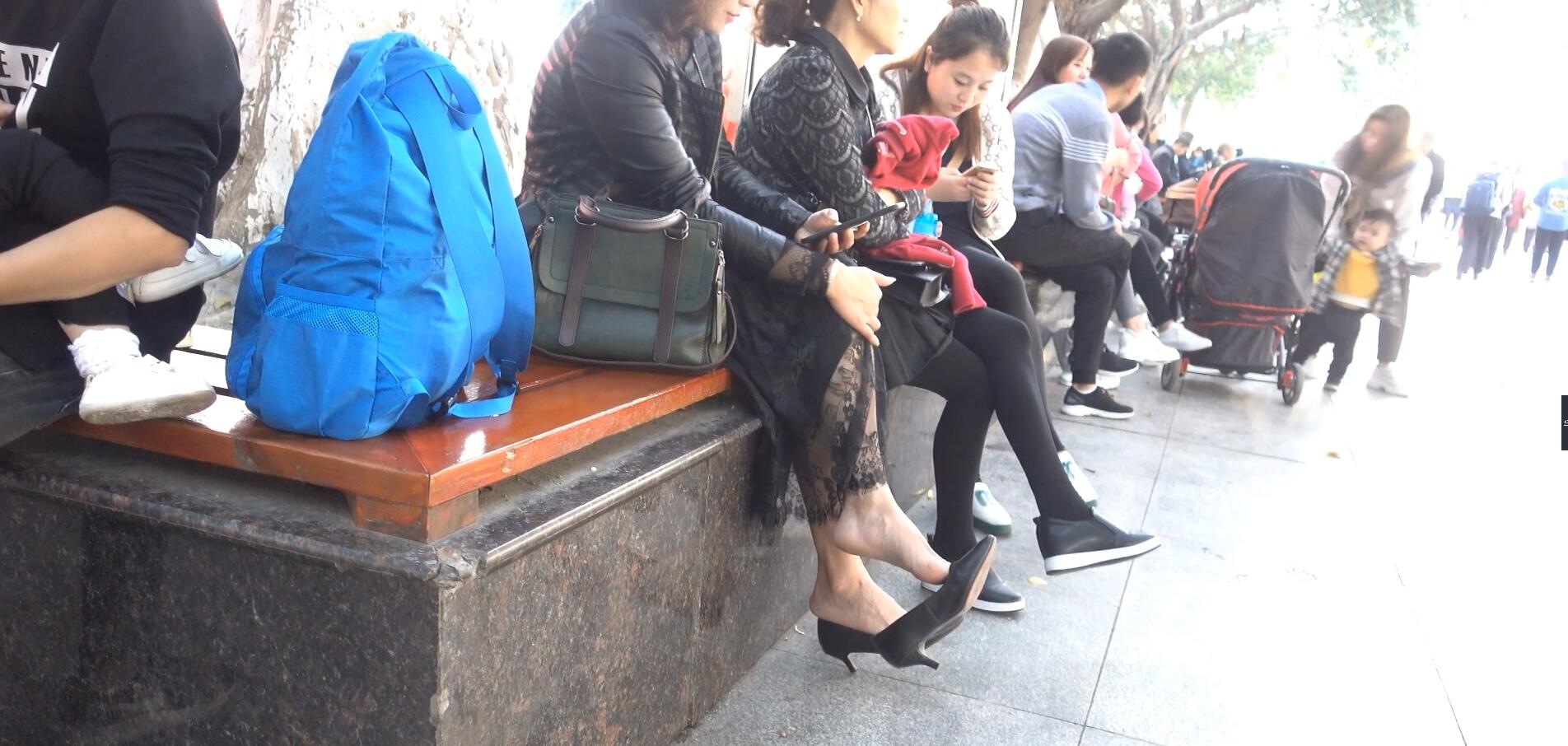 Middle-aged woman bare feet dangling shot