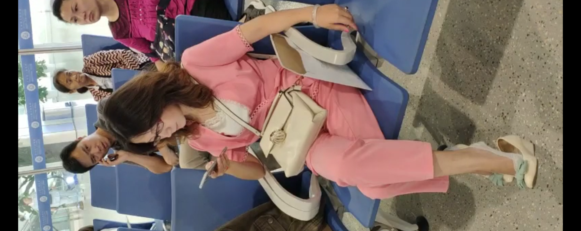 Lady dangling shoeplay when line up in the waiting hall 12