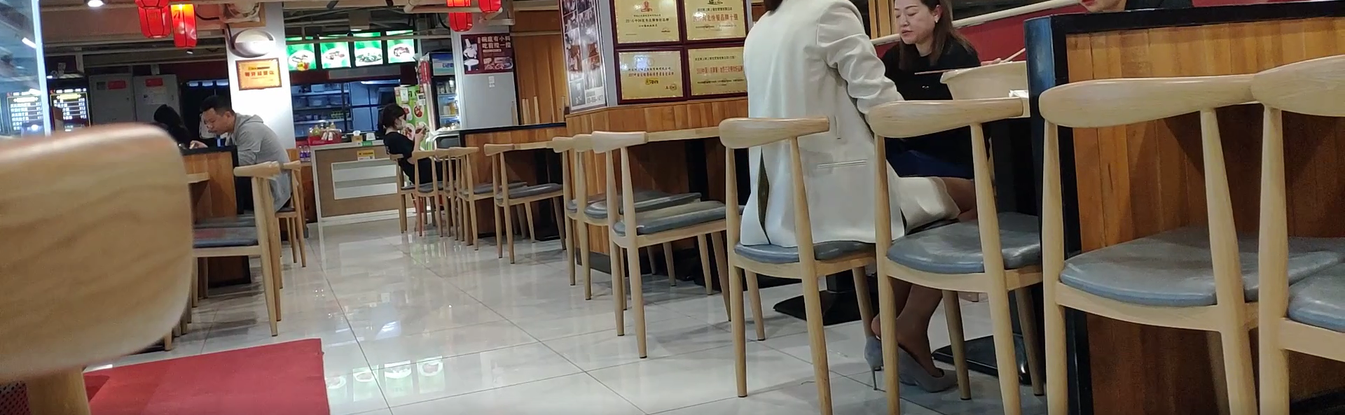 The girl dangling shoeplay under the table when having lunch 17